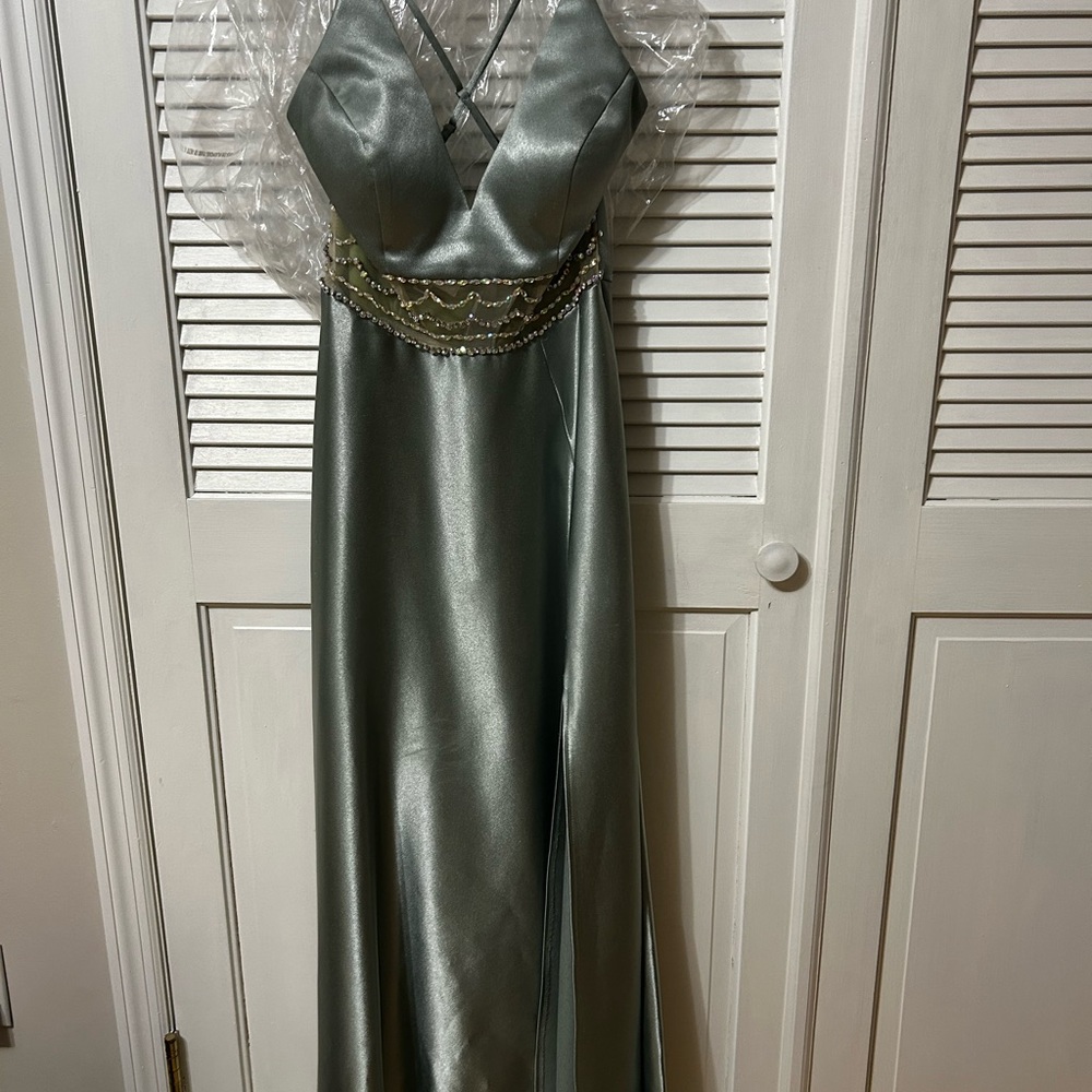 Prom dress in sage green. Satin material with embellishments at the waist.